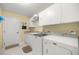 Well-equipped laundry room with white appliances, ample cabinet space, and a utility sink at 8352 Se 168Th Trinity Pl, The Villages, FL 32162