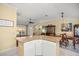 Open living space featuring a kitchen bar, dining area, and view towards the front entrance at 8352 Se 168Th Trinity Pl, The Villages, FL 32162