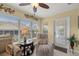 Bright sunroom filled with natural light, featuring an outdoor view, tiled flooring and neutral furniture at 8352 Se 168Th Trinity Pl, The Villages, FL 32162
