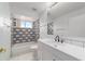 Bathroom featuring patterned shower tile, white vanity, and modern fixtures at 8463 Sw 108Th Ln, Ocala, FL 34481
