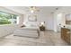 Bright bedroom featuring a large window, neutral color scheme and ensuite bath at 8463 Sw 108Th Ln, Ocala, FL 34481