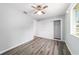 Bedroom with wood-look floors, ceiling fan, window and closet with sliding doors at 8463 Sw 108Th Ln, Ocala, FL 34481