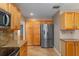 Kitchen featuring wooden cabinets, stainless steel refrigerator, and ample storage space at 8463 Sw 108Th Ln, Ocala, FL 34481