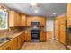 Well-lit kitchen with wooden cabinets, stainless steel appliances, and tile flooring at 8463 Sw 108Th Ln, Ocala, FL 34481