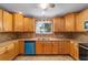 Traditional kitchen featuring wooden cabinets, tile backsplash, and stainless steel sink at 8463 Sw 108Th Ln, Ocala, FL 34481
