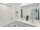 Bright bathroom featuring a double sink vanity, white cabinetry, and a shower over a soaking tub at 8647 Sw 44Th Ter, Ocala, FL 34476