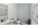 Half bathroom with a toilet, small vanity, mirror, decor, and plant accent for added greenery at 8647 Sw 44Th Ter, Ocala, FL 34476