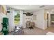 Bright bedroom featuring neutral walls, a large window, and space for a workspace or play area at 8647 Sw 44Th Ter, Ocala, FL 34476