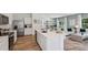 Open-concept kitchen featuring a large island with stainless steel appliances and views of the living area at 8647 Sw 44Th Ter, Ocala, FL 34476