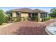 Backyard with stone landscaping and manicured greenery, providing a tranquil and low-maintenance outdoor space at 8650 Sw 83Rd Loop, Ocala, FL 34481