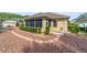 Backyard with stone landscaping and fountain, surrounded by lush greenery for a private and serene setting at 8650 Sw 83Rd Loop, Ocala, FL 34481