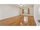 Bright bedroom with wood floors, ceiling fan, and window with wooden shutters at 8650 Sw 83Rd Loop, Ocala, FL 34481