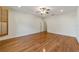 Spacious bedroom with wood floors, ceiling fan, and window with wooden shutters at 8650 Sw 83Rd Loop, Ocala, FL 34481