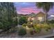 Charming home featuring lush landscaping, beautiful bushes, and a well-manicured lawn at sunset at 8650 Sw 83Rd Loop, Ocala, FL 34481