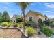 Beautiful home with lush landscaping, stone-edged garden beds, and a mature palm tree at 8650 Sw 83Rd Loop, Ocala, FL 34481