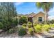 Well-maintained home featuring lush landscaping, decorative bushes, and an inviting entrance at 8650 Sw 83Rd Loop, Ocala, FL 34481