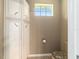 Compact half-bathroom with built-in storage and neutral color palette at 8650 Sw 83Rd Loop, Ocala, FL 34481
