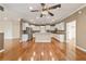 Spacious kitchen featuring white cabinets, granite countertops, stainless steel appliances, and wood flooring at 8650 Sw 83Rd Loop, Ocala, FL 34481