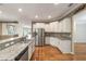 Kitchen boasts granite countertops, stainless steel appliances, a breakfast bar, and wood floors at 8650 Sw 83Rd Loop, Ocala, FL 34481