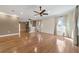 Open-concept living room with hardwood flooring, ceiling fan and lots of natural light at 8650 Sw 83Rd Loop, Ocala, FL 34481