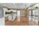 Open concept living room and kitchen featuring white cabinets and stainless appliances at 8650 Sw 83Rd Loop, Ocala, FL 34481