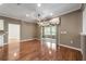 Bright living room with dark brown accent wall and view into outdoor living space at 8650 Sw 83Rd Loop, Ocala, FL 34481