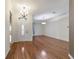 Bright living room with wood flooring, modern lighting, and an open entryway for entertaining at 8650 Sw 83Rd Loop, Ocala, FL 34481