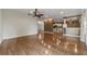 Hardwood floors in living room leading to the kitchen with modern white cabinets at 8650 Sw 83Rd Loop, Ocala, FL 34481