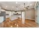 Bright open floor plan with white cabinets, hardwood flooring and recessed lighting at 8650 Sw 83Rd Loop, Ocala, FL 34481