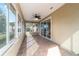 Cozy sunroom with a ceiling fan, sliding glass doors, and tile floors that offers versatile space for relaxation at 8650 Sw 83Rd Loop, Ocala, FL 34481