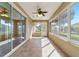 Inviting sunroom with tile floors, ceiling fan, and sliding doors for seamless indoor-outdoor living and enjoyment at 8650 Sw 83Rd Loop, Ocala, FL 34481