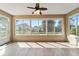 Bright sunroom with tile flooring, large windows, and ceiling fan for comfortable relaxation and natural light at 8650 Sw 83Rd Loop, Ocala, FL 34481