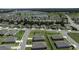 Aerial view of a residential neighborhood with a large pond and many homes at 8870 Sw 62Nd Ave, Ocala, FL 34476