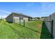 Spacious backyard featuring a chain-link fence and green grass at 8870 Sw 62Nd Ave, Ocala, FL 34476