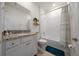 Bright bathroom with a granite countertop vanity, white cabinets, and a shower-tub combo at 8870 Sw 62Nd Ave, Ocala, FL 34476