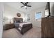 Comfortable bedroom features a ceiling fan, two windows, and stylish furnishings for a cozy living space at 8870 Sw 62Nd Ave, Ocala, FL 34476