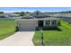 Inviting single-Gathering home with a manicured front lawn and a two-car garage at 8870 Sw 62Nd Ave, Ocala, FL 34476
