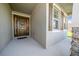Inviting front porch showcasing a beautifully adorned front door with decorative wreath at 8870 Sw 62Nd Ave, Ocala, FL 34476