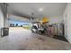 Spacious garage with ample storage, a golf cart, and easy access to the outdoors at 8870 Sw 62Nd Ave, Ocala, FL 34476