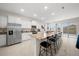 Bright kitchen with granite counters, stainless appliances, an island with seating, and sliding doors to the lanai at 8870 Sw 62Nd Ave, Ocala, FL 34476