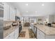This kitchen features granite countertops, stainless appliances, and an island with views of the dining and living areas at 8870 Sw 62Nd Ave, Ocala, FL 34476
