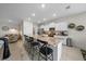 Modern kitchen features a granite island with bar seating, stainless steel appliances, and ample cabinet space at 8870 Sw 62Nd Ave, Ocala, FL 34476