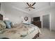 Spacious main bedroom with a ceiling fan, a TV, a queen bed, and access to the main bathroom at 8870 Sw 62Nd Ave, Ocala, FL 34476