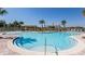 Stunning community pool with ample seating and lush landscaping under a clear blue sky at 8870 Sw 62Nd Ave, Ocala, FL 34476