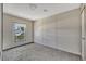 Bedroom with neutral walls and carpet, a window view, and a white door at 9100 Sw 32Nd Ct, Ocala, FL 34476