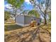 Grey manufactured home with wooden steps, a white door, and a manicured yard at 9100 Sw 32Nd Ct, Ocala, FL 34476