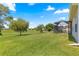 Expansive backyard with lush green lawn and screened lanai at 9628 Sw 90Th St, Ocala, FL 34481
