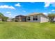 The backyard features a screened lanai, lush green lawn and beautiful views at 9628 Sw 90Th St, Ocala, FL 34481
