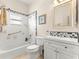 Bright bathroom with tiled shower, framed mirror, and white vanity offers a clean and modern design at 9628 Sw 90Th St, Ocala, FL 34481