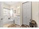 Bathroom features a shower-tub combo, white vanity, framed mirror, and a decorative tiled backsplash at 9628 Sw 90Th St, Ocala, FL 34481